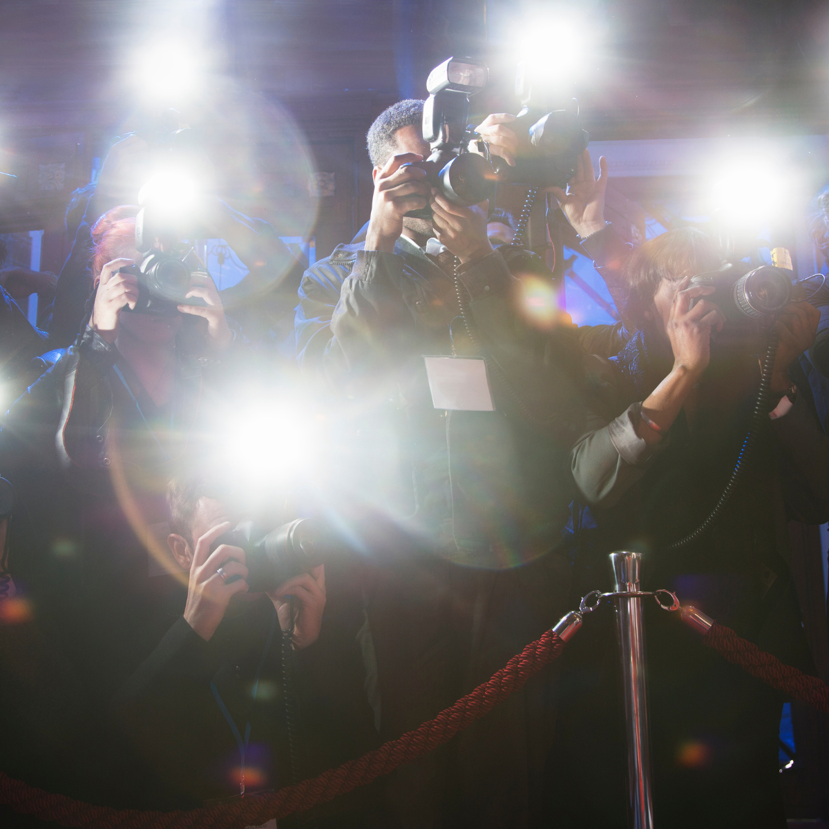 flashing cameras on a red carpet