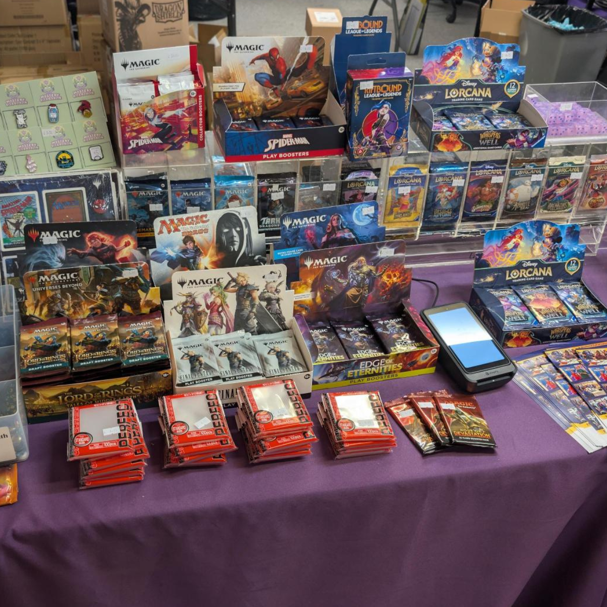 Table full of MTG, Lorcana and Rifbound products